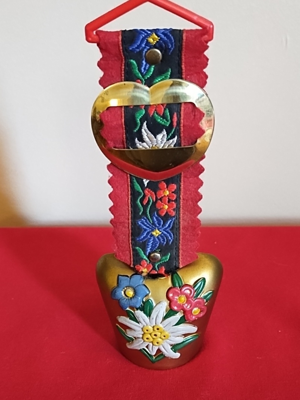 ALPINE SOUVENIR COWBELL, HAND PAINTED BRASS,EDELWEISS FLORAL MOTIF ON BRASS BELL